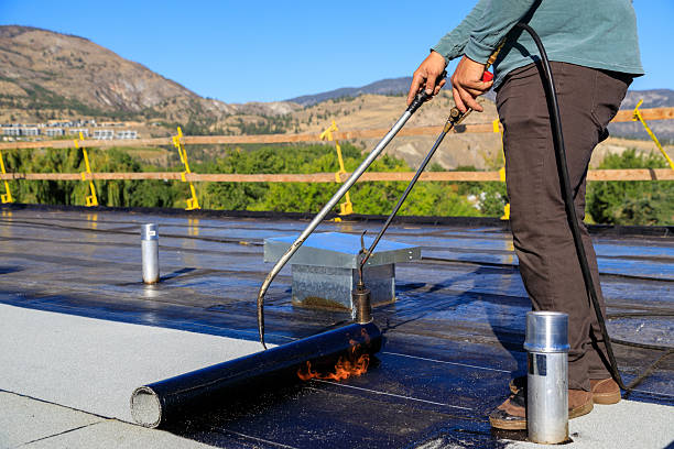 istock Roofer applying torch to bitumen membrane on torch down roof 2237928403