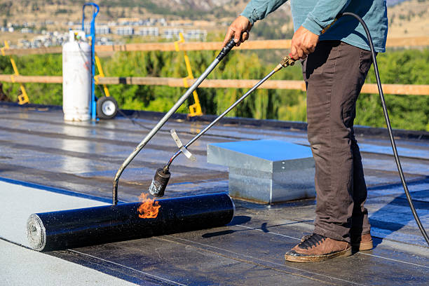 istock Roofer applying torch to bitumen membrane on torch down roof 2237928404