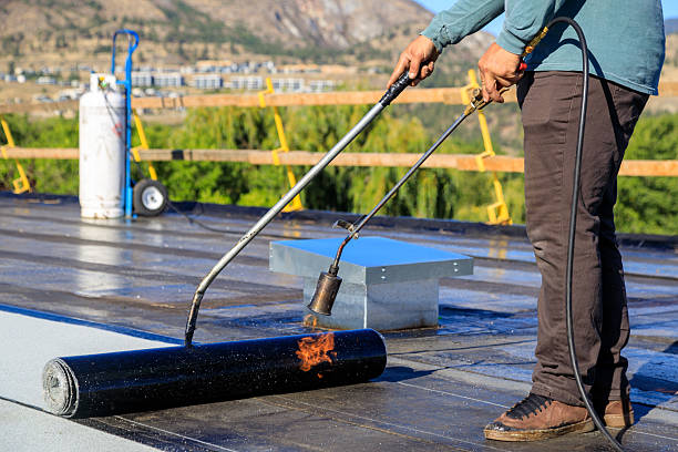 istock Roofer applying torch to bitumen membrane on torch down roof 2237928406