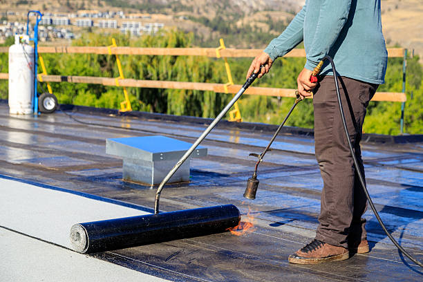 istock Roofer applying torch to bitumen membrane on torch down roof 2237928414
