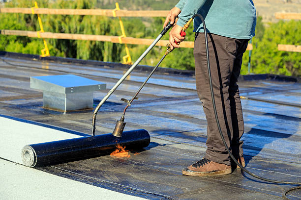 istock Roofer applying torch to bitumen membrane on torch down roof 2237928419