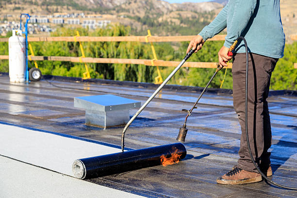 istock Roofer applying torch to bitumen membrane on torch down roof 2237928420