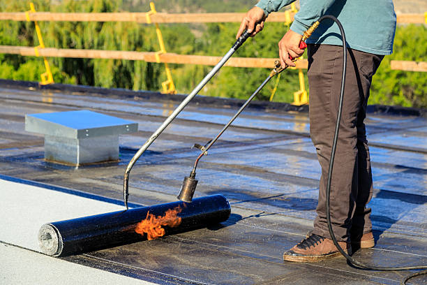 istock Roofer applying torch to bitumen membrane on torch down roof 2237928421