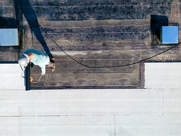 istock Roofer applying torch to bitumen membrane on torch down roof 2237928429