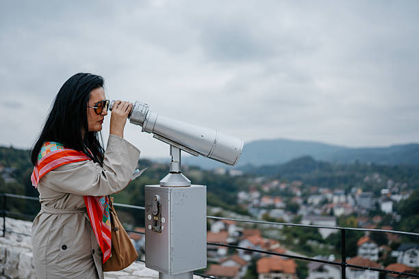 istock Woman using coin-operated binoculars overlooking town 2237933251