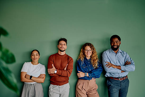 istock Diverse business team standing confident against green wall 2237933415
