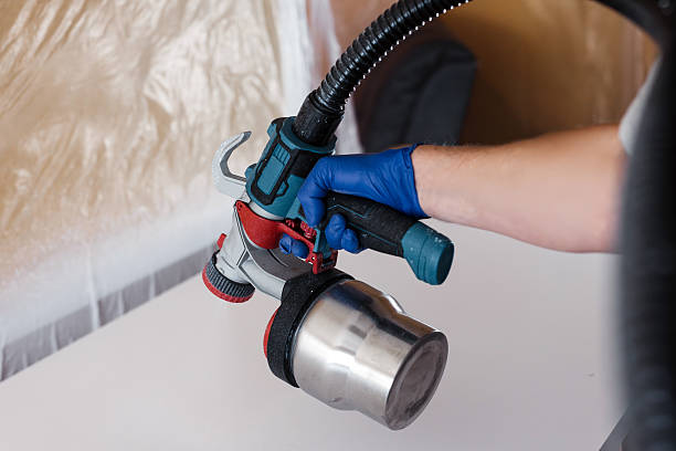 istock Skilled individual using a paint sprayer to apply a fresh coat of paint on a smooth surface 2237933582