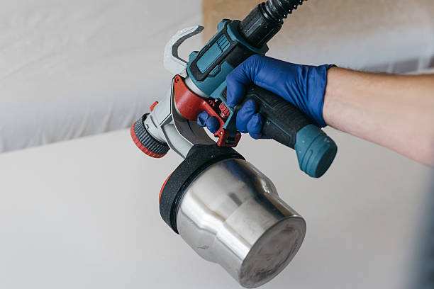 istock Skilled individual using a paint sprayer to apply a fresh coat of paint on a smooth surface 2237933583