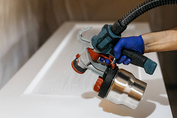 istock Skilled individual using a paint sprayer to apply a fresh coat of paint on a smooth surface 2237933605