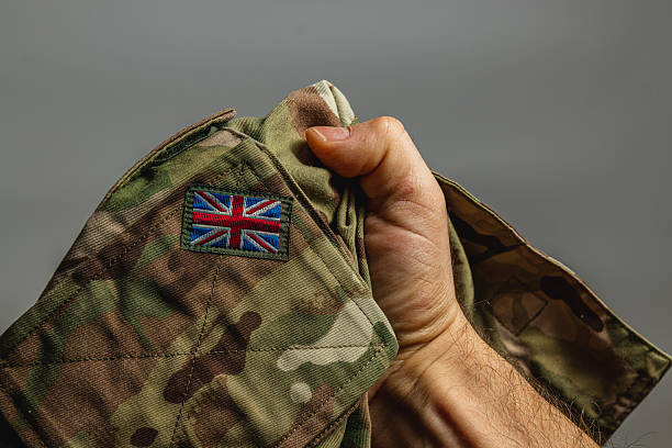 istock Close-up of a hand holding a military uniform patch with flag 2237937345