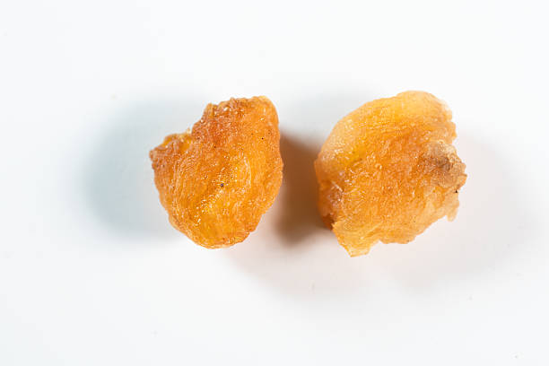 A vibrant and abundant dried fruit cocktail served on a white plate, placed on a striking blue tablecloth. The rich colors of the fruits stand out against the clean backdrop, creating a visually appealing and appetizing presentation