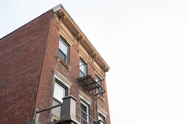 Multi-storey building with balconies against the sky on a sunny day.