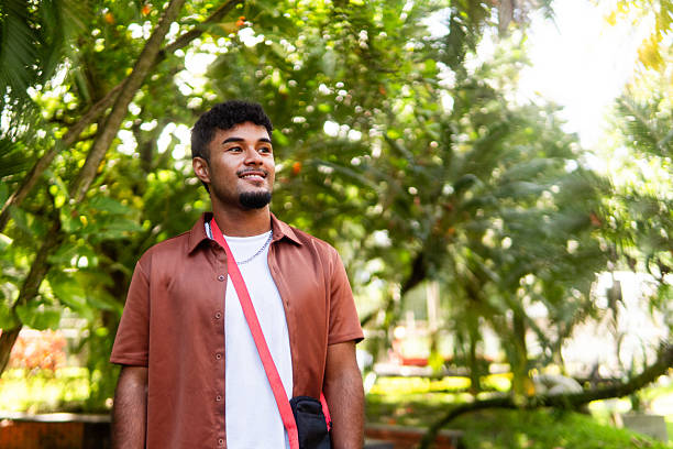 istock Young hispanic man smiling outdoors in park 2237946709