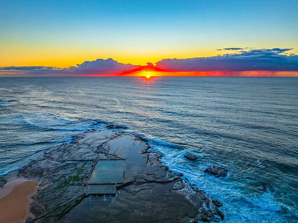 istock Sunrise at the beach with low cloud bank 2237946911