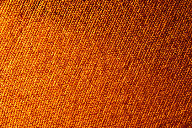 orange texture of knitted wool fabric as a background, orange smooth symmetrical lines of hand-knitted needlework pattern