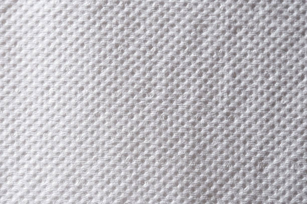 Macro view of white paper with a soft, textured surface and visible fibers, ideal for stationery, backgrounds, or design mockups.