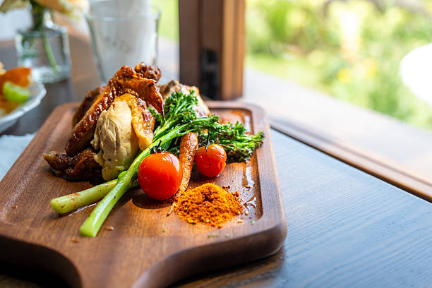 istock Delicious Roasted Chicken with Vegetables Served on a Wooden Platter 2237951699