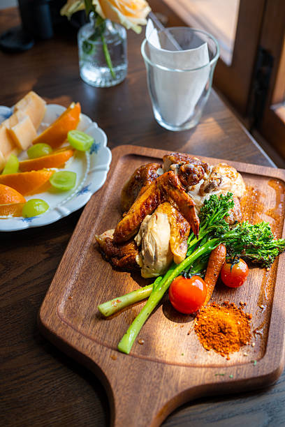 Delicious Roasted Chicken with Vegetables Served on a Wooden Board