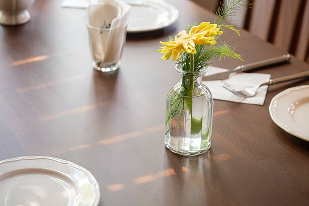 istock A Delicate Flower Vase on a Wooden Dining Table, Creating a Warm and Inviting Atmosphere 2237952817