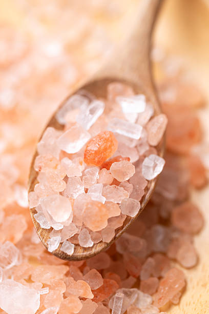 Himalayan pink salt in wooden spoon