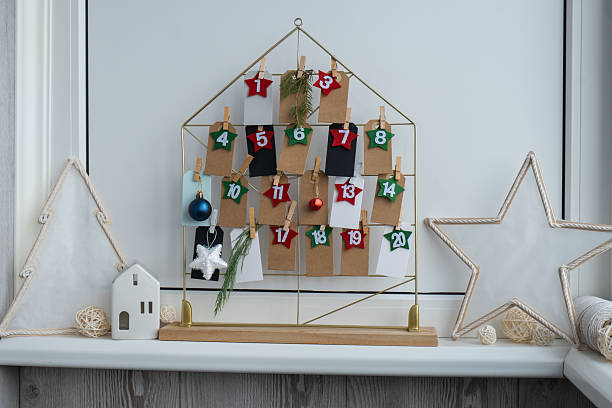 istock Number on craft paper notes with tasks before Christmas holidays. Female making kraft paper for handmade advent calendar Made with your own hands step by step DIY 2237964418