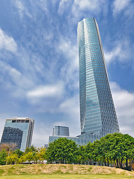 istock A Modern Skyscraper Towering Over the Cityscape Under a Blue Sky with Scattered Clouds 2237965356