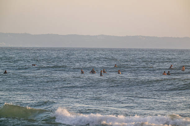 A group of surfers in the water