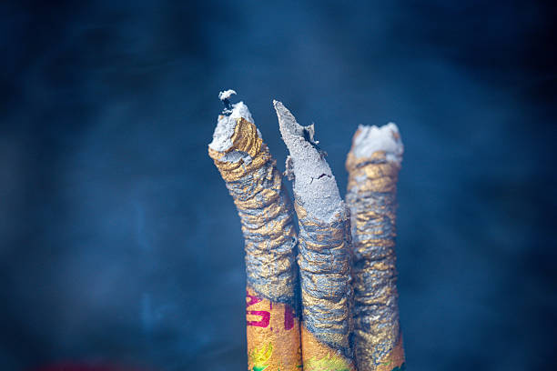 Burning Incense Sticks with Smoke Rising in a Serene Atmosphere