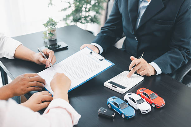 istock Businessman explaining car loan agreement with calculator, customer discussing auto finance deal at office desk with toy car and document, concept of vehicle loan, insurance or car leasing. car loan. 2237968619