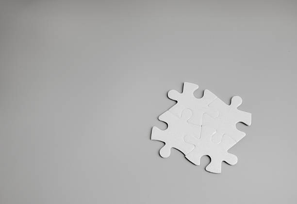 Four puzzle pieces connected together on gray background symbolizing teamwork, business solution, strategy integration, corporate collaboration. Unity, problem solving, organization success concept.