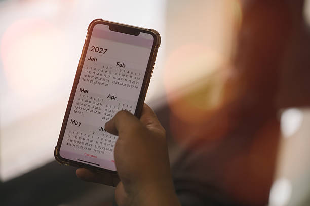 istock Concept for time management and financial planning reminder 2027. man using smartphone working with year 2027 calendar, business planning marketing and investment 2237970263