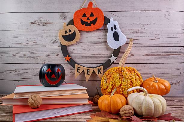 istock Halloween wreath featuring pumpkins, ghosts, jack-o'-lanterns, and books. 2237974845