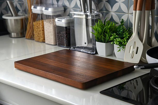 istock Modern kitchen countertop with blank wooden cutting board 2237977135