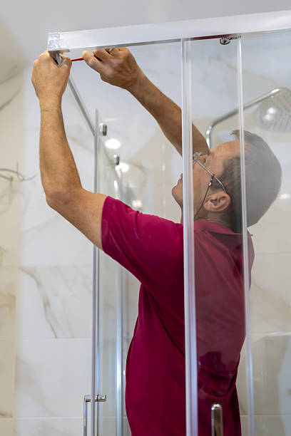 istock A mature plumber fixing shower stall, work in bathroom. 2237977322