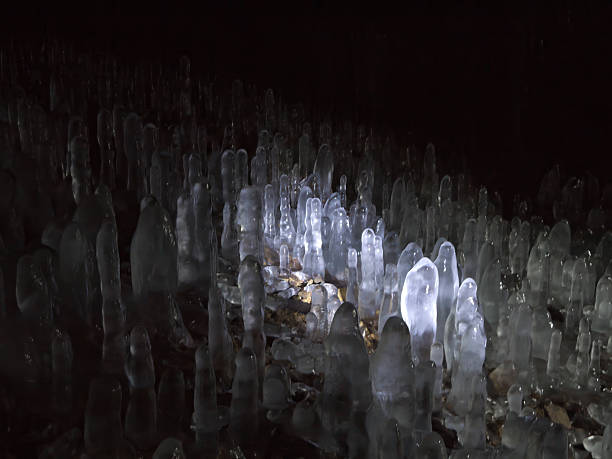 istock Ice stalactites in the dark cave 2237978345