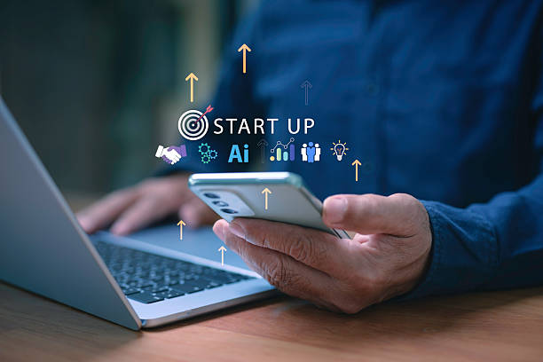 istock Entrepreneur using laptop and smartphone with digital icons startup, AI, growth, and innovation, symbolizing new business, technology, teamwork, investment, and successful entrepreneurship. 2237979309
