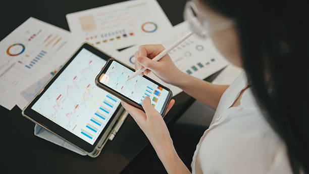 istock professional financial analyst comparing tablet data with paper statement review of corporate business performance documents 2237980014