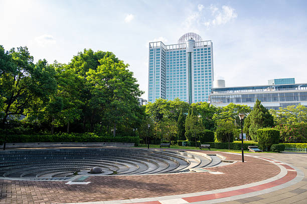 istock A Modern Circular Amphitheater in an Urban Setting Surrounded by Lush Greenery and Tall Buildings 2237980931