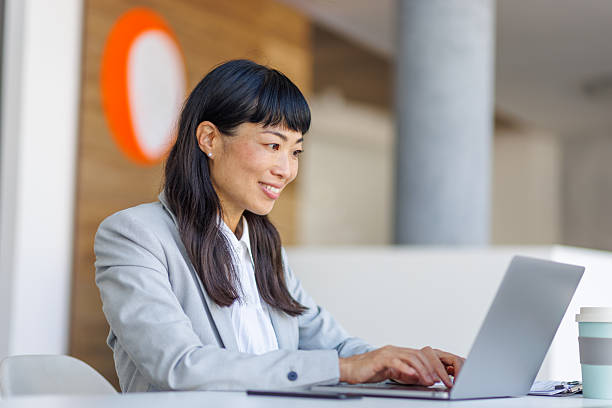 istock Businesswoman working on laptop in modern office 2237981075