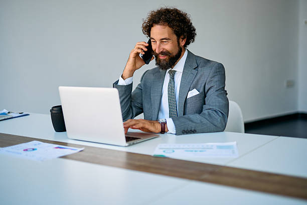 istock Businessman talking on phone and working on laptop in office 2237981589