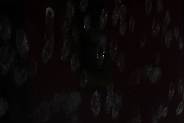white fingerprints stuck to the black glass surface