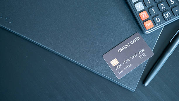 istock Dark themed setup with black credit card pen and calculator on folder creating professional atmosphere linked to finance credit control and business accounting. 2237982930