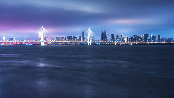 istock Dramatic sky and clouds with modern urban waterfront skyline at night 2237983024