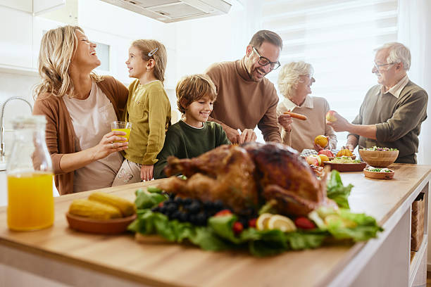 istock Happy extended family talking on Thanksgiving at kitchen counter. 2237983535