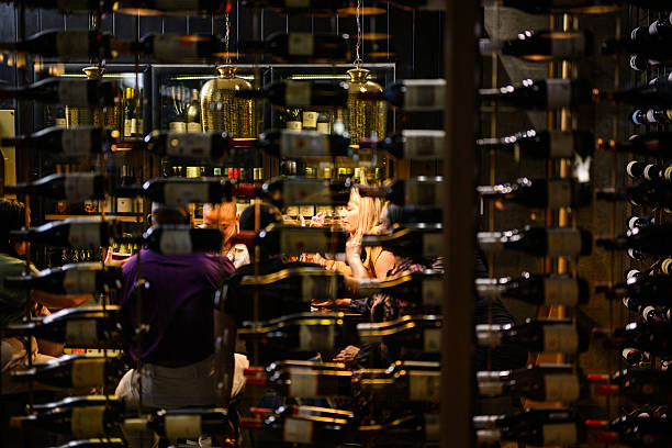 istock View through wine racks showing guests enjoying tasting experience at illuminated hotel cellar bar 2237985478
