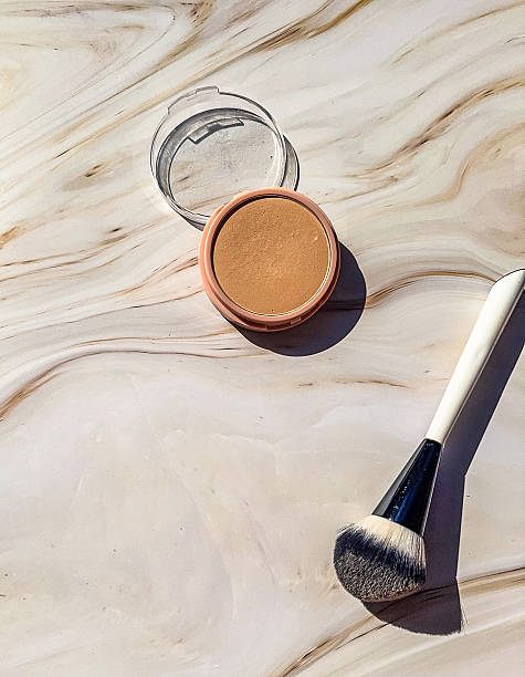 istock Compact Powder with Makeup Brush on Marble Background 2237986574