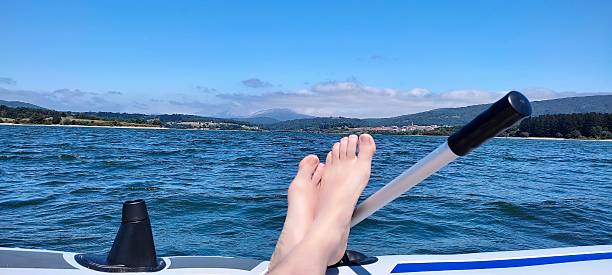 istock Feet relaxing on boat at summer lake 2237989816