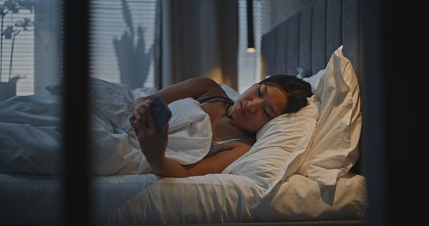 istock Young Woman Relaxing in Bed After Day's Work 2237989845