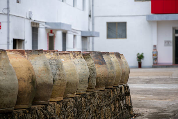 A Wall of Ancient Terracotta Jars in a Traditional Courtyard