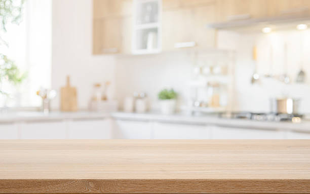 istock Wooden table top for food product presentation with blurred light kitchen interior background 2237991049